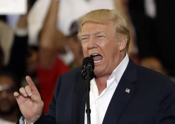President Donald Trump gestures during the "Make America Great Again Rally" at Orlando-Melbourne International Airport. (AP Photo/Chris O'Meara)