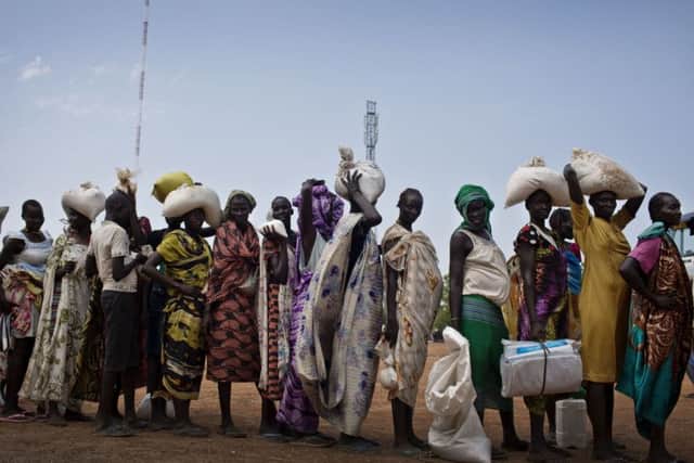 Women who fled fighting queue for food aid at a food distribution site in Bentiu, South Sudan. (Kate Holt/UNICEF via AP)