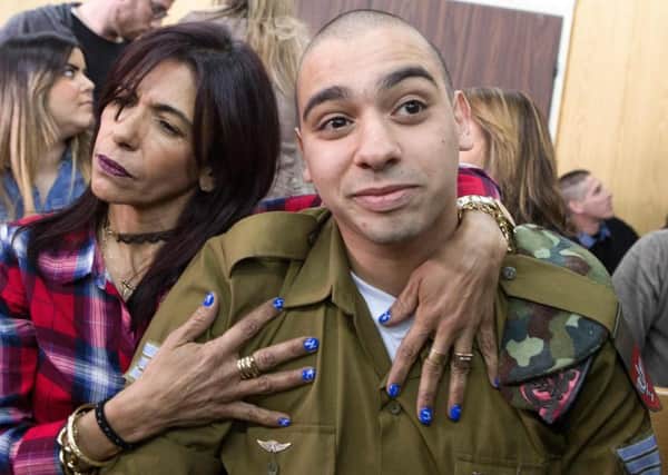 Israeli soldier Elor Azaria is embraced by his mother Oshra before his sentencing session at a Tel Aviv military court. Picture: AFP/Getty Images