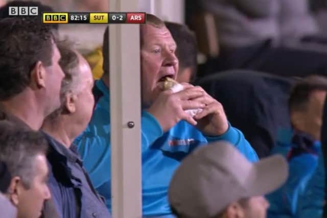 Sutton's reserve goalkeeper Wayne Shaw eating a pie on the touchline. Picture: BBC/PA