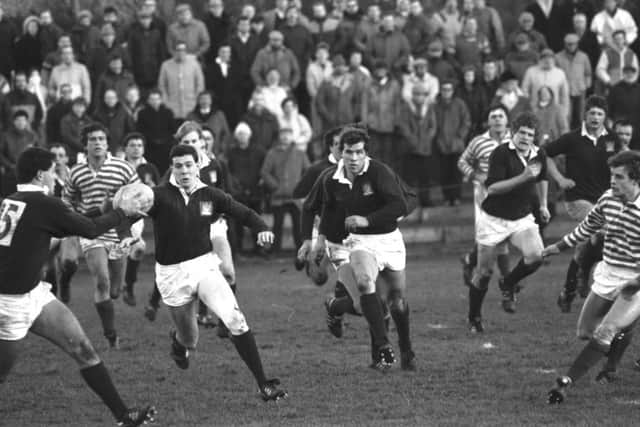 Gavin Hastings (with ball) gets the ball from brother Scott Hastings
