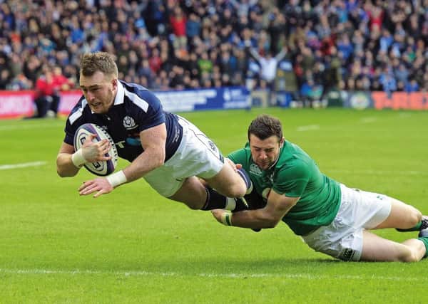 Scotland full-back Stuart Hogg scores his first try despite the efforts of Irelands Robbie Henshaw