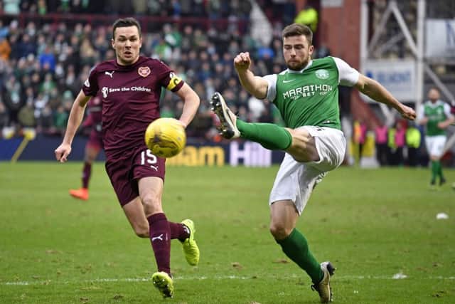 Hibernian's Lewis Stevenson gets the cross in under pressure from Hearts' Don Cowie (left) during the 0-0 draw at Tynecastle. Picture: SNS