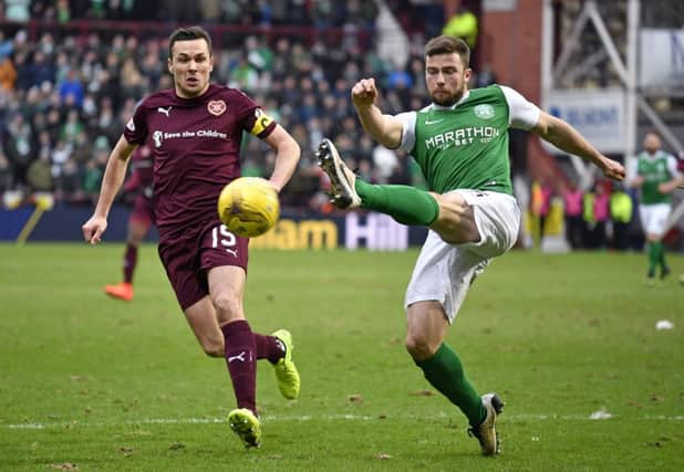 Hibernian's Lewis Stevenson gets the cross in under pressure from Hearts' Don Cowie (left) during the 0-0 draw at Tynecastle. Picture: SNS