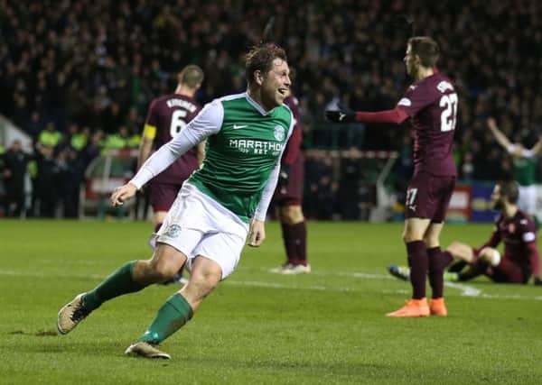 Grant Holt celebrates putting Hibs two up against Hearts