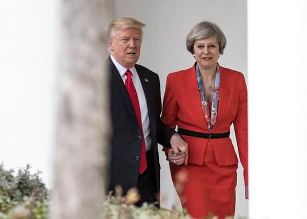US President Donald Trump and UK Prime Minister Theresa May hold hands for comfort in an increasingly uncertain world. Picture: Christopher Furlong/Getty Images