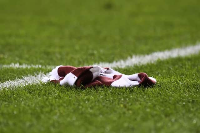 A Hearts scarf lies on the pitch as the club are knocked out of the Scottish Cup by Hibs. Picture: SNS