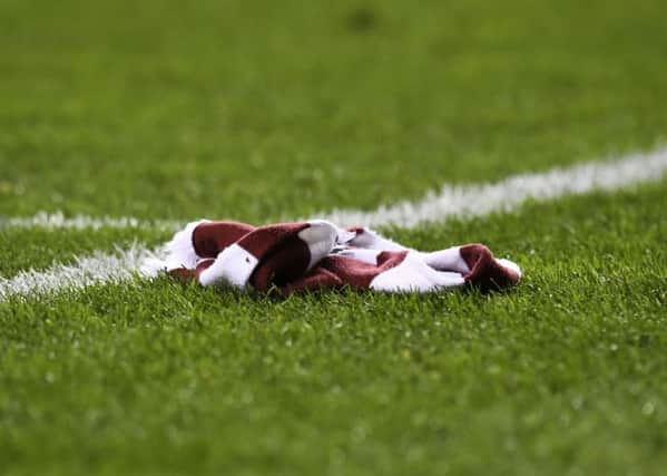 A Hearts scarf lies on the pitch as the club are knocked out of the Scottish Cup by Hibs. Picture: SNS