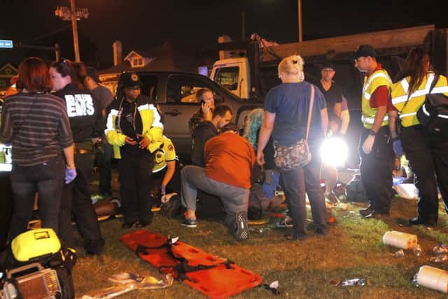 New Orleans emergency personnel attend to injured parade watchers. (Scott Threlkeld/AP)