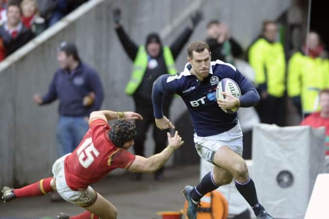 Tim Visser storms past Welsh full-back Leigh Halfpenny to score Scotlands second try. Picture: Neil Hanna.