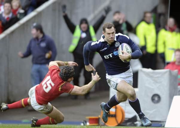 Tim Visser storms past Welsh full-back Leigh Halfpenny to score Scotlands second try. Picture: Neil Hanna.