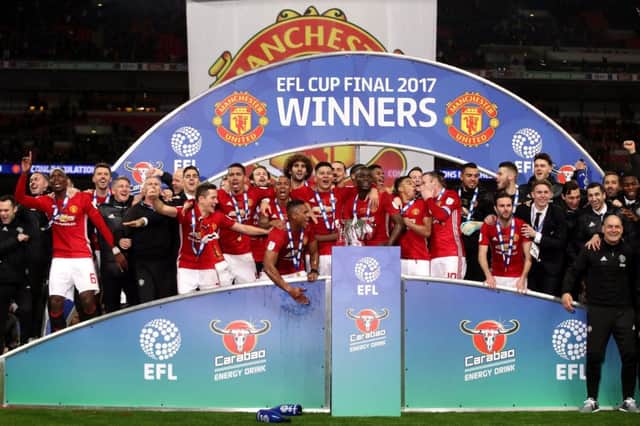 Manchester United players celebrate after their cup victory. Picture: PA