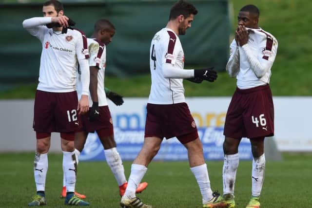 Hearts players trudge off the field at full-time after Saturdays 2-0 defeat by Partick Thistle. Picture: SNS.