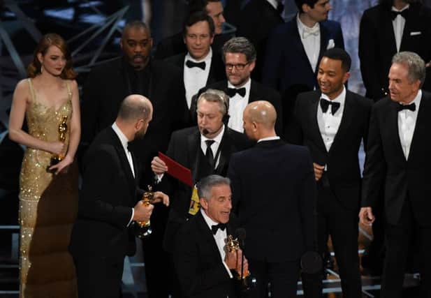 La La Land producer Jordan Horowitz (second left) speaks to stage manager Gary Natoli (centre) after the film mistakenly won the best picture instead of Moonlight at the 89th Oscars. Picture: AFP/Mark Ralston/Getty Images