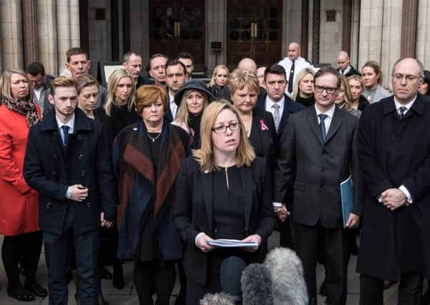 Surrounded by families of victims, solicitor Kylie Hutchison, from law firm Irwin Mitchell, reveals plans to sue travel giant TUI. Picture: Getty Images