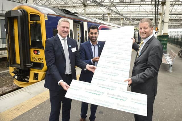 Dominic Booth celebrating the first birthday of the Borders Railway in September with transport minister Humza Yousaf and Phil Verster. Picture: Greg Macvean
