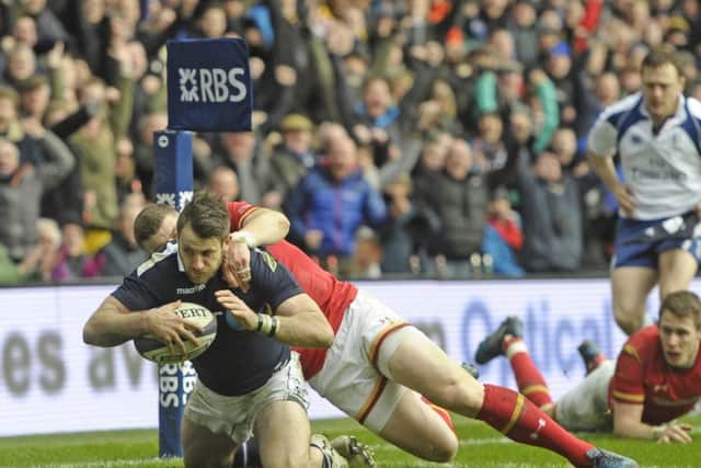 Scotland winger
Tommy Seymour scores a try despite a desperate tackle by Scott Williams of Wales. Picture: Neil Hanna