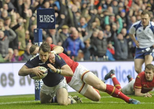 Scotland winger
Tommy Seymour scores a try despite a desperate tackle by Scott Williams of Wales. Picture: Neil Hanna
