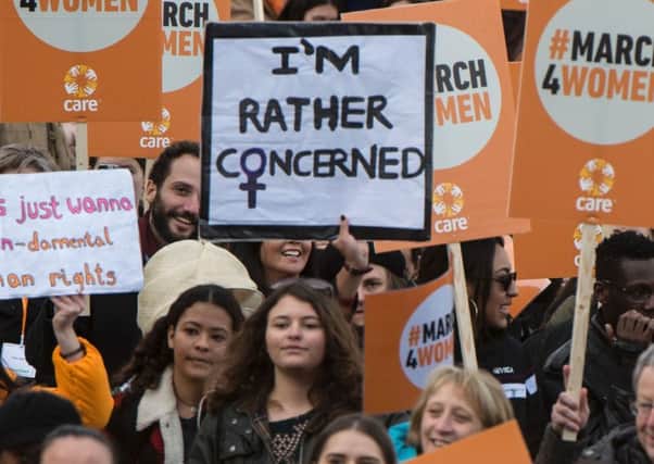 People hold placards as they take part in a gender equality march.  (Picture: Chris Radcliffe/Getty