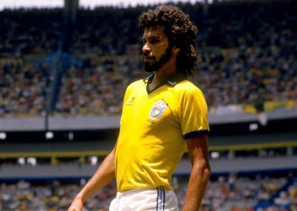 Brazil's Socrates takes a rest during the 1986 World Cup match against Spain at the Jalisco Stadium in Guadalajara, Mexico. Picture: Mike King/Allsport
