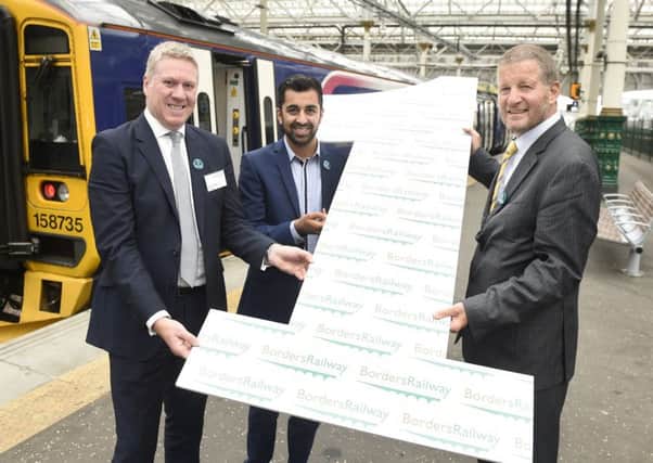 Abellio UK managing director Dominic Booth celebrates the first anniversary of the Borders Railway last September with transport minister Humza Yousaf and then ScotRail managing director Phil Verster. Picture: Greg Macvean