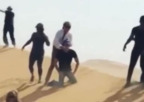 A screen shot from a video in which Rod Stewart 're-enacts' an Isis-style beheading