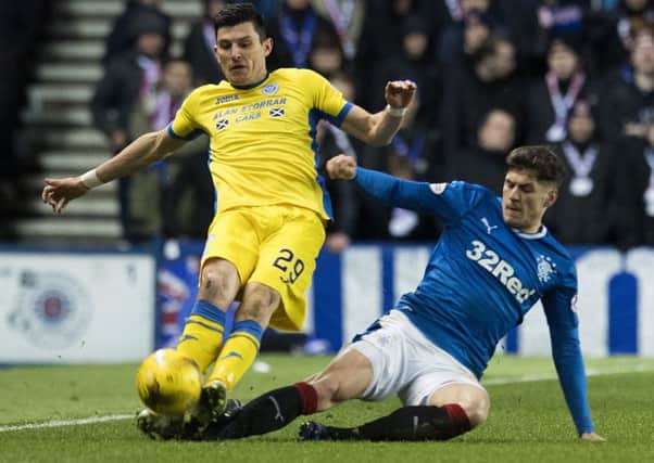 Rob Kiernan fouls St Johnstone's Graham Cummins and is shown a red card. Picture: SNS