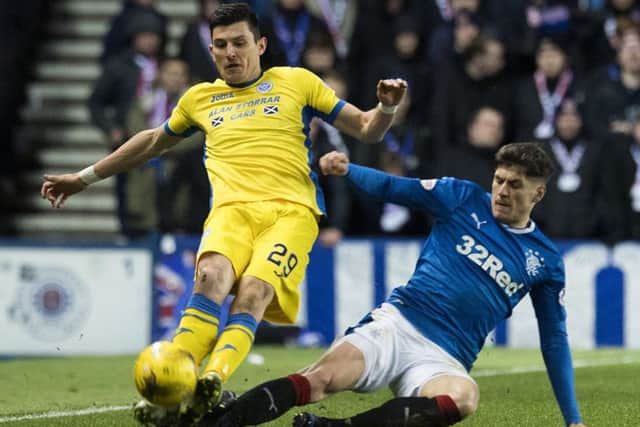 Rob Kiernan fouls St Johnstone's Graham Cummins and is shown a red card. Picture: SNS