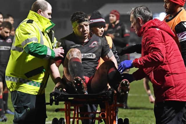 Edinburgh's Alasdair Dickinson is carted off after being injured against Ospreys. Picture: Rob Casey/SNS