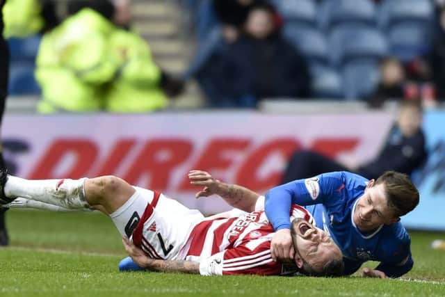Joe Garner and Dougie Imrie tangle after the Rangers player's late challenge the Hamilton striker. Picture: Rob Casey/SNS