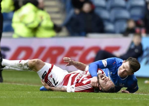 Joe Garner and Dougie Imrie tangle after the Rangers player's late challenge the Hamilton striker. Picture: Rob Casey/SNS