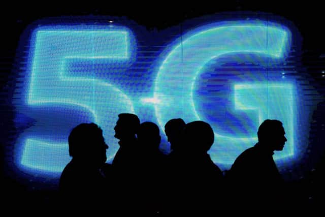 Visitors walk past a 5G logo during the Mobile World Congress in Barcelona. Picture: Josep Lago/AFP/Getty Images