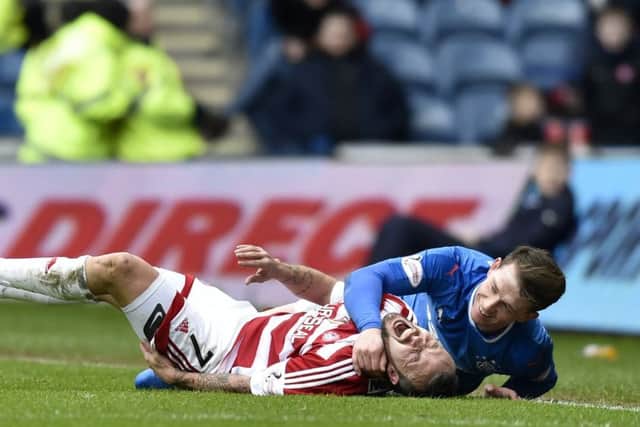 Rangers' Joe Garner (right) after a late challenge on Dougie Imrie. Picture: SNS