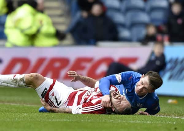 Rangers' Joe Garner (right) after a late challenge on Dougie Imrie. Picture: SNS