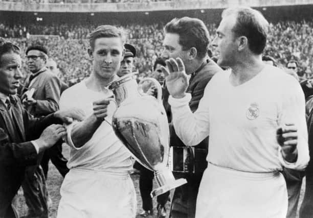 Raymond Kopa, left, and Alfredo Di Stefano hold the European Cup in the Bernabeu stadium in Madrid after Real's victory over Italy's Fiorentina in 1957. Picture: AFP