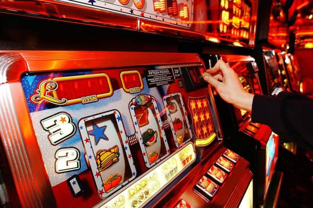 A gambler putting money into a slot machine in an amusement arcade in Portobello. A major shake-up of betting laws aims to give Britain's faded seaside resorts a shot in the arm by revolutionising the way bets are placed.