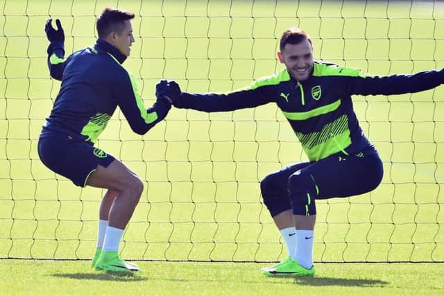 Arsenals Alexis Sanchez, left,  trains yesterday with  Lucas Perez. Picture: AFP/Getty.