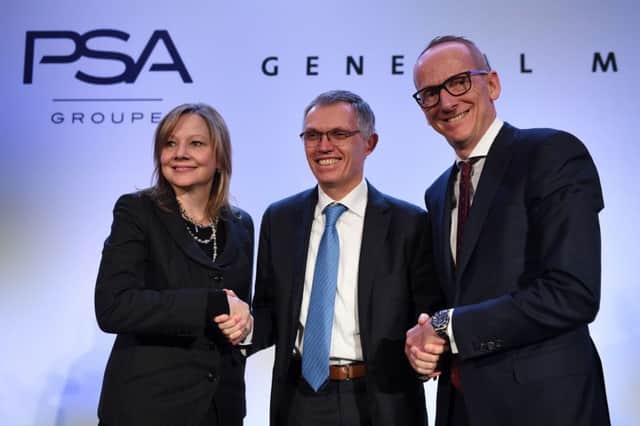 Mary Barra of GM, Carlos Tavares of PSA and Opels chief executive Karl Thomas Neumann shake hands on the deal. Picture: AFP/Getty Images