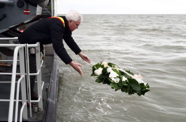 West-Flanders province governor Carl Decaluwe throws a wreath to the sea during a tribute ceremony for the 30th anniversary of the Herald of Free Enterprise ferry disaster, on March 6, 2017 off  Zeebrugge. Picture: AFP/Getty Images