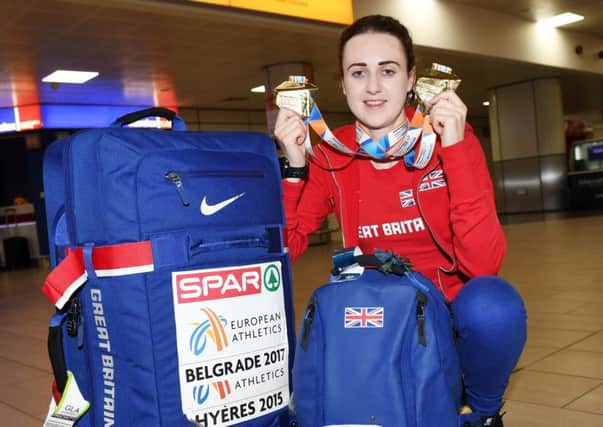 Laura Muir shows off her two gold medals at Glasgow Airport after winning the 3,000 and 1,500m titles at the European Indoor Championships. Picture: SNS