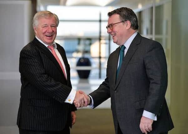 Aberdeen Asset Management chief Martin Gilbert, left, shakes hands on the deal with Standard Life boss Keith Skeoch. Picture: Graham Flack