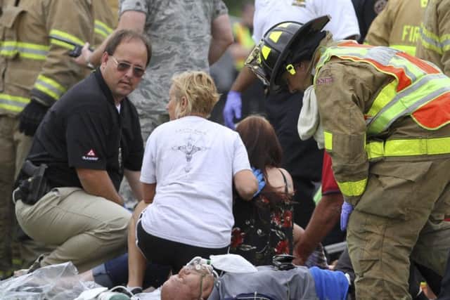 Rescue personnel treat passengers. ( John Fitzhugh/The Sun Herald via AP)