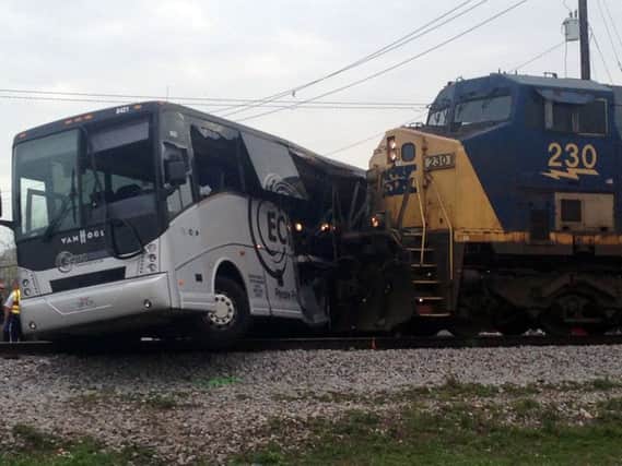 A freight train smashed into a charter bus in Biloxi, Mississippi,   pushing the bus 300 feet down the tracks (AP Photo/Kevin McGill)