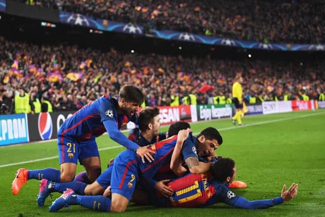 Sergi Roberto is jumped upon by his Barcelona team mates after his dramatic sixth goal completed the astonishing comeback against Paris Saint-Germain.  Picture: Laurence Griffiths/Getty Images