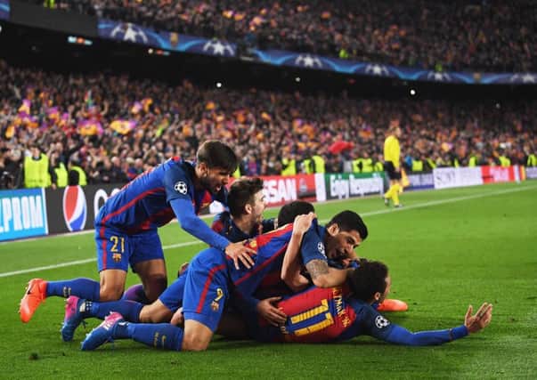Sergi Roberto is jumped upon by his Barcelona team mates after his dramatic sixth goal completed the astonishing comeback against Paris Saint-Germain.  Picture: Laurence Griffiths/Getty Images
