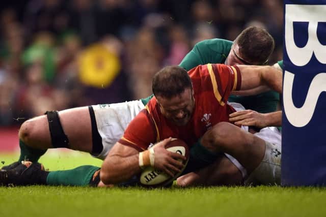 Jamie Roberts forces his way over to score Wales third try in their 22-9 victory over Ireland. Picture: PA.