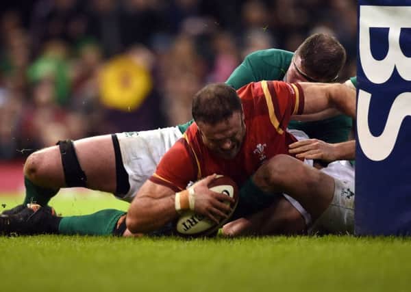 Jamie Roberts forces his way over to score Wales third try in their 22-9 victory over Ireland. Picture: PA.