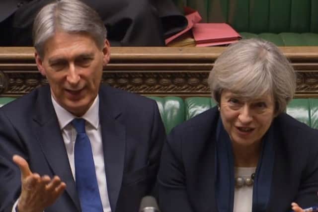 Prime Minister Theresa May, right, and Philip Hammond. Picture: PA