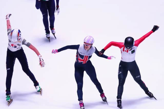 Elise Christie, centre, crosses the line first with Marianne St-Gelais, right, in second. Photograph: Dean Mouhtaropoulos/Getty