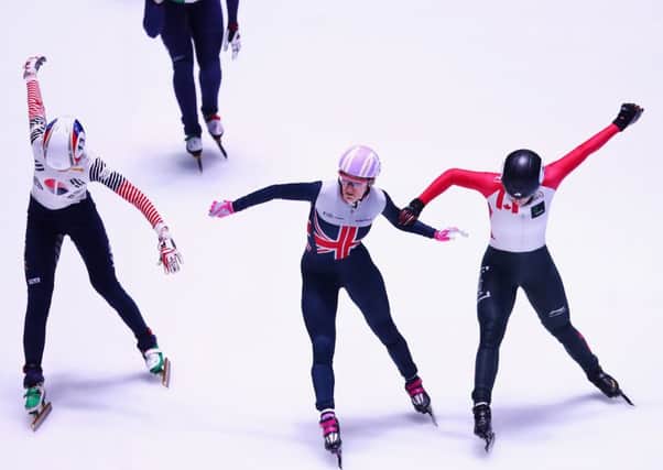 Elise Christie, centre, crosses the line first with Marianne St-Gelais, right, in second. Photograph: Dean Mouhtaropoulos/Getty